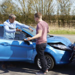 Two drivers argue after an auto accident to illustrate What To Do When At-Fault Driver Will Not Respond